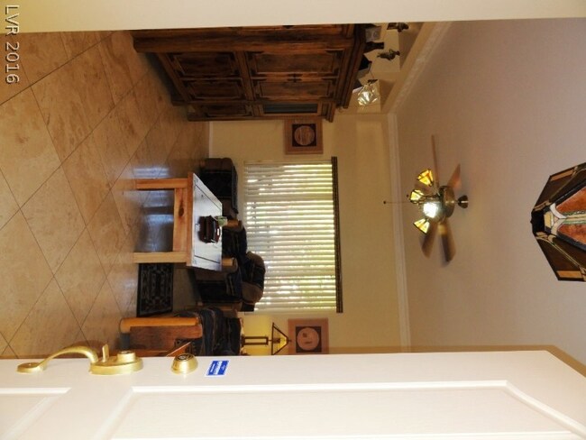 ENTRY TO THE LIVING ROOM WITH TRAVERTINE FLOORS AN