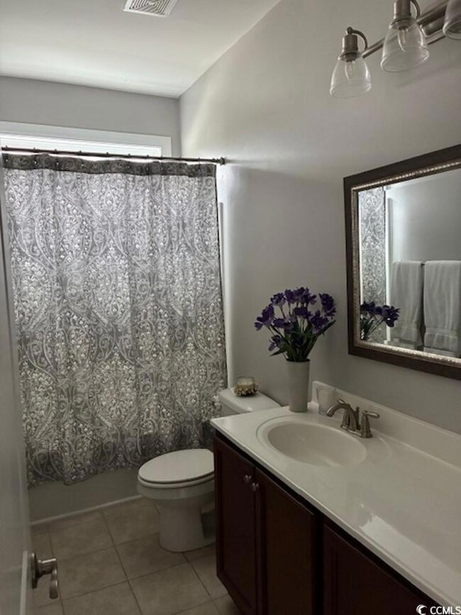 Bathroom featuring vanity, tile patterned floors, 