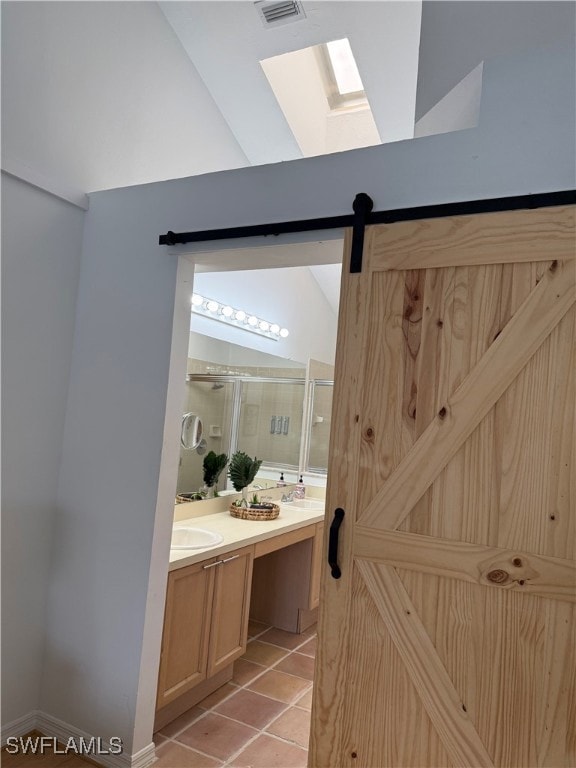 Full bathroom featuring a skylight, double vanity,