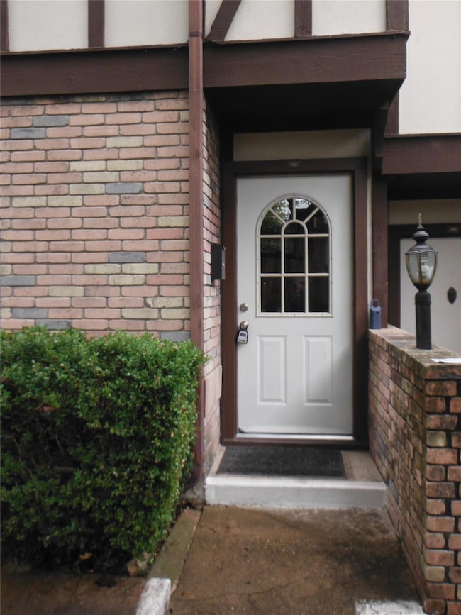 View of exterior entry featuring brick siding