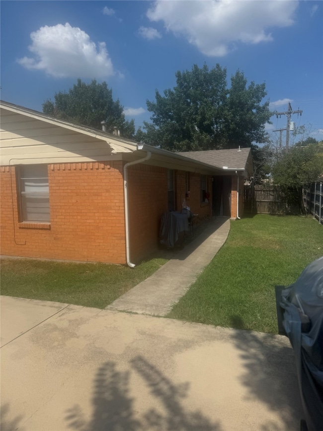 View of side of property featuring brick siding