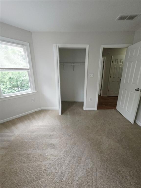 Unfurnished bedroom featuring carpet floors and a closet
