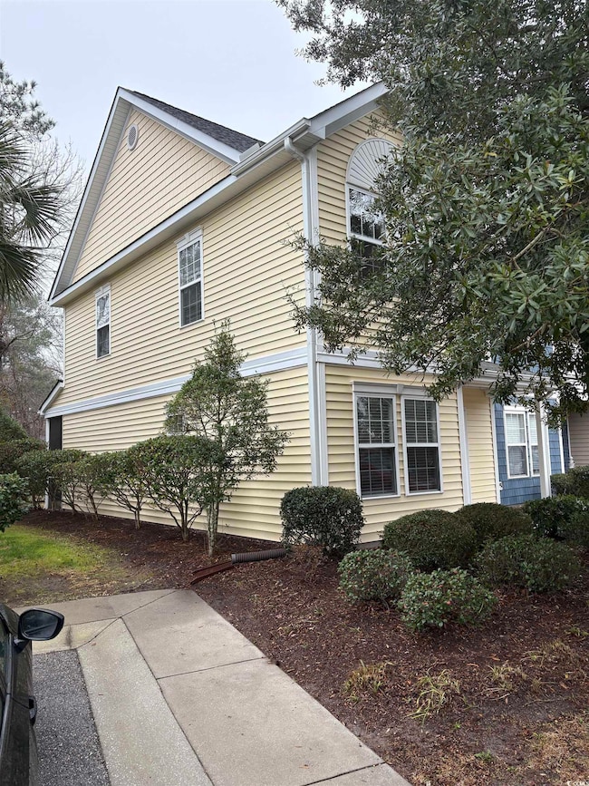 View of side of home with a patio