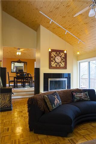 Your great room features vaulted beadboard ceiling, track lighting a gas fireplace and hardwood flooring. The great room and dining room lead out to the upper deck which boasts beautiful views.