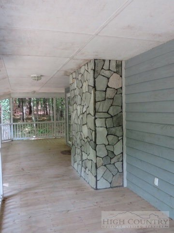 Side Covered Porch: Nice stone rock fireplace chimney.  Great place to entertain family and guest.