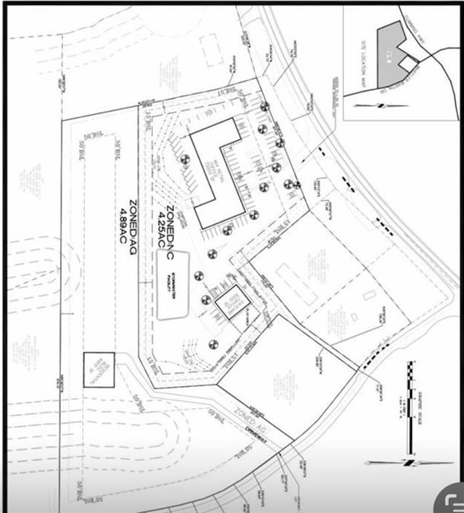 Aerial overview of property's location with property parcel outlined and a forest