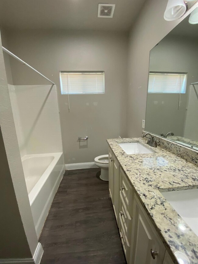 Full bathroom featuring baseboards, visible vents,