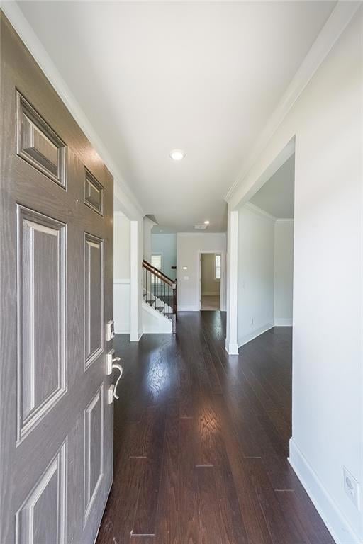 Entrance foyer with stairway, dark wood-style flooring, ornamental molding, and recessed lighting