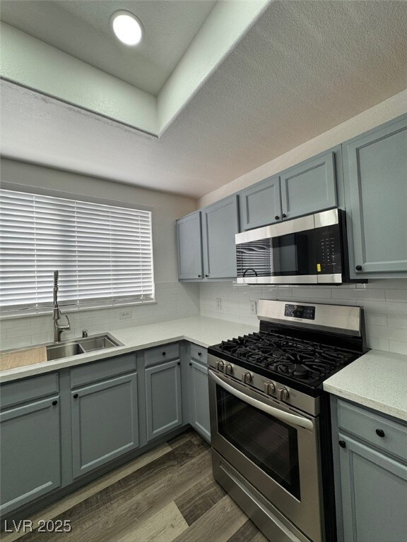 Kitchen with stainless steel appliances, dark wood
