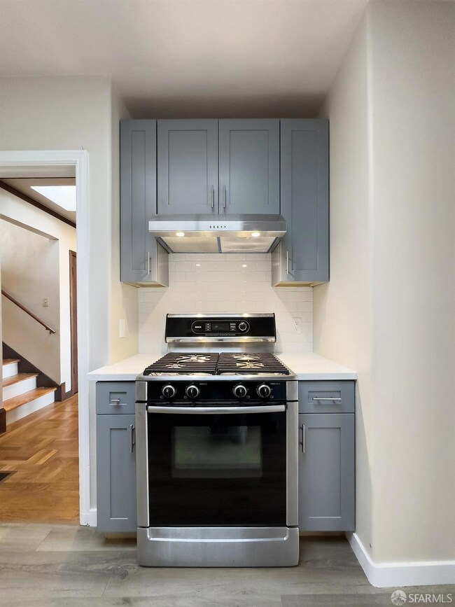 Custom wood cabinets; new stainless hood over Bosc