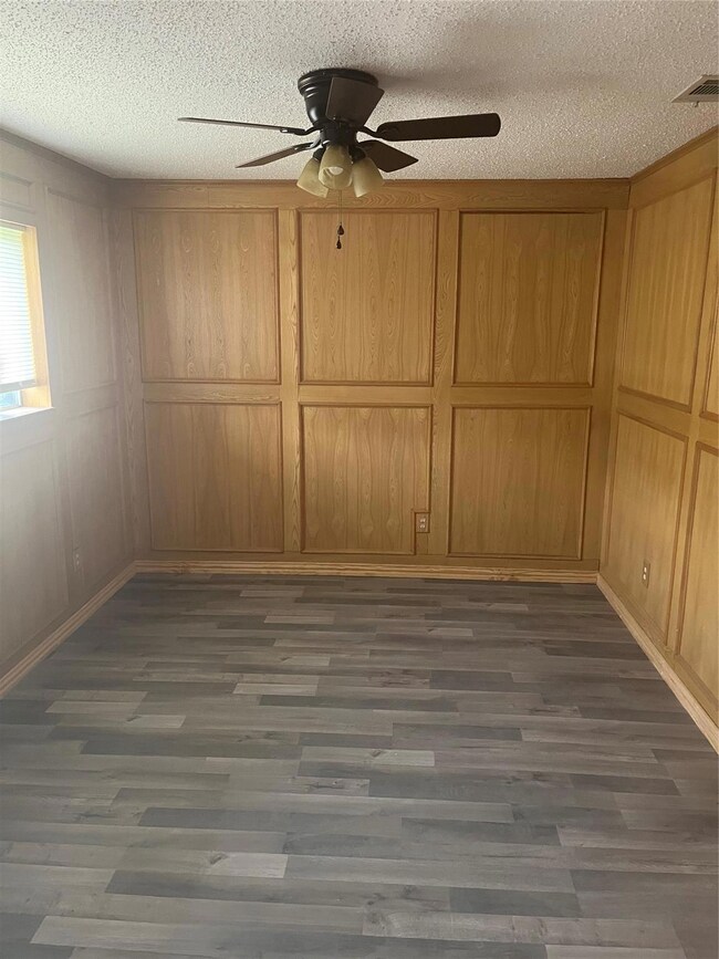 Room with picture-frame paneling, wood-style floor