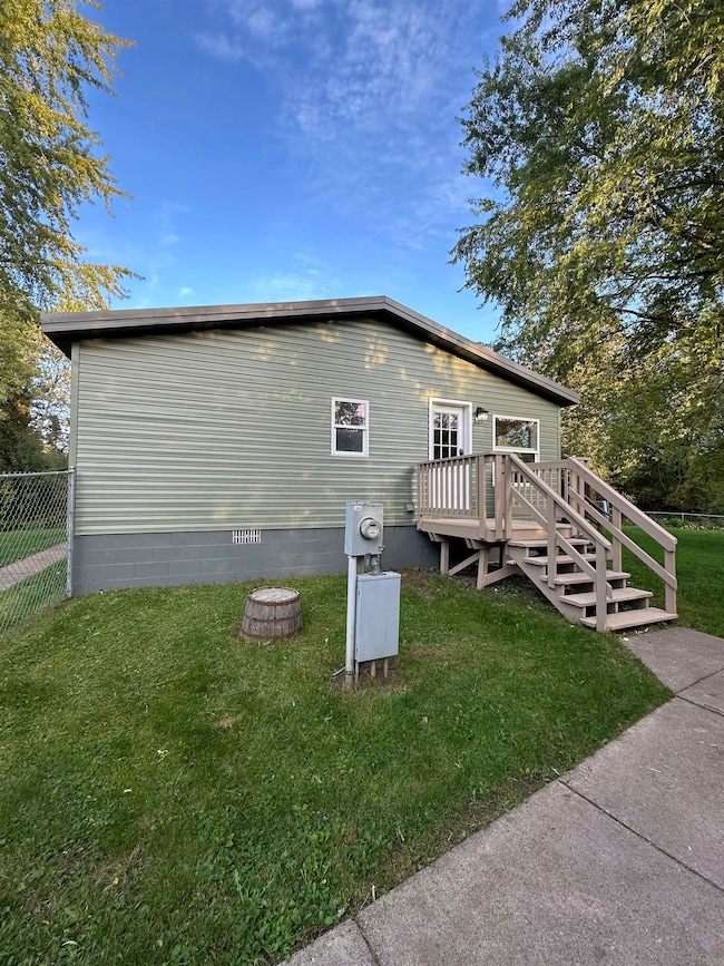 View of side of home with a deck