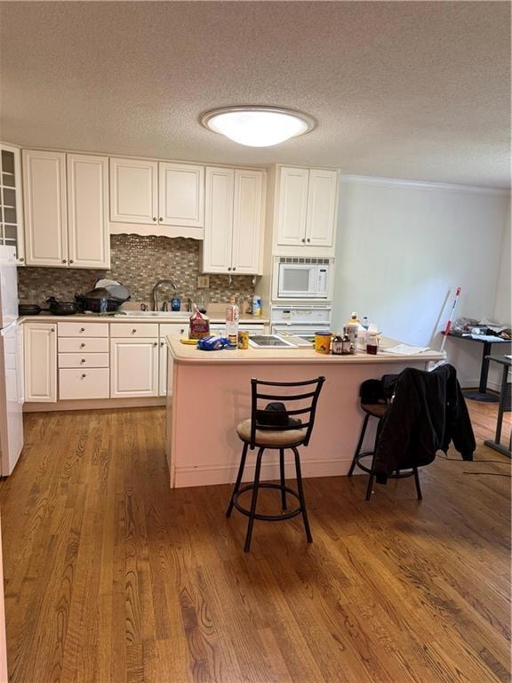Bedroom with wood finished floors, baseboards, and