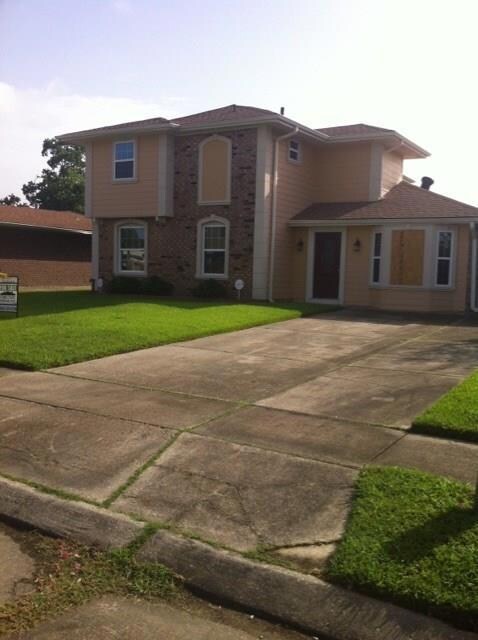 Front view. Driveway accommodates several cars.