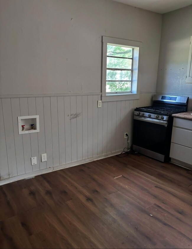 kitchen featuring wainscoting, laundry area, and d