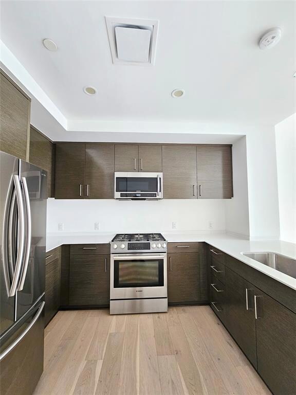 Kitchen with dark brown cabinetry, modern cabinet