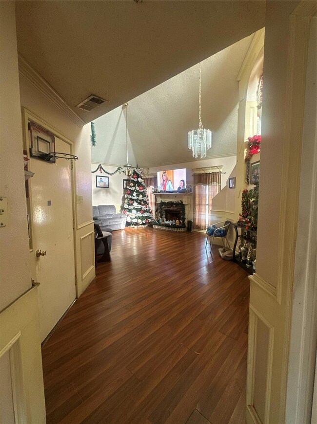 Bonus room featuring an inviting chandelier, vault