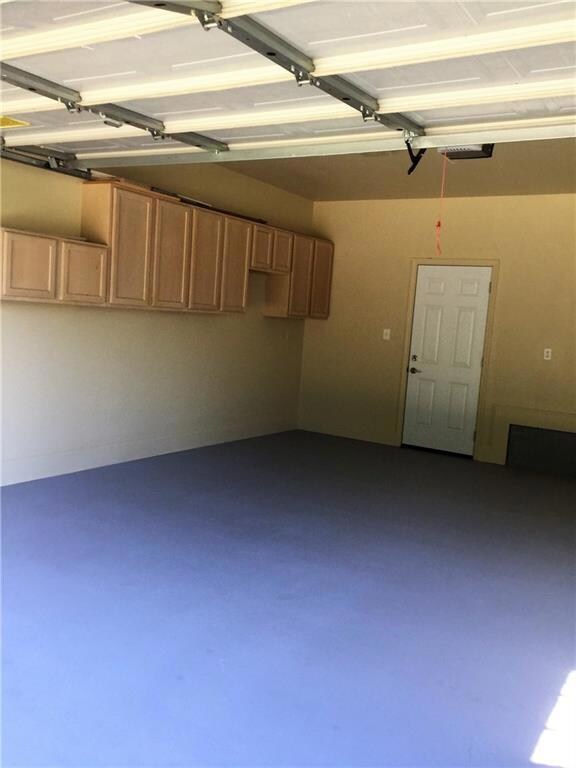 Super clean garage with built in cabinets.