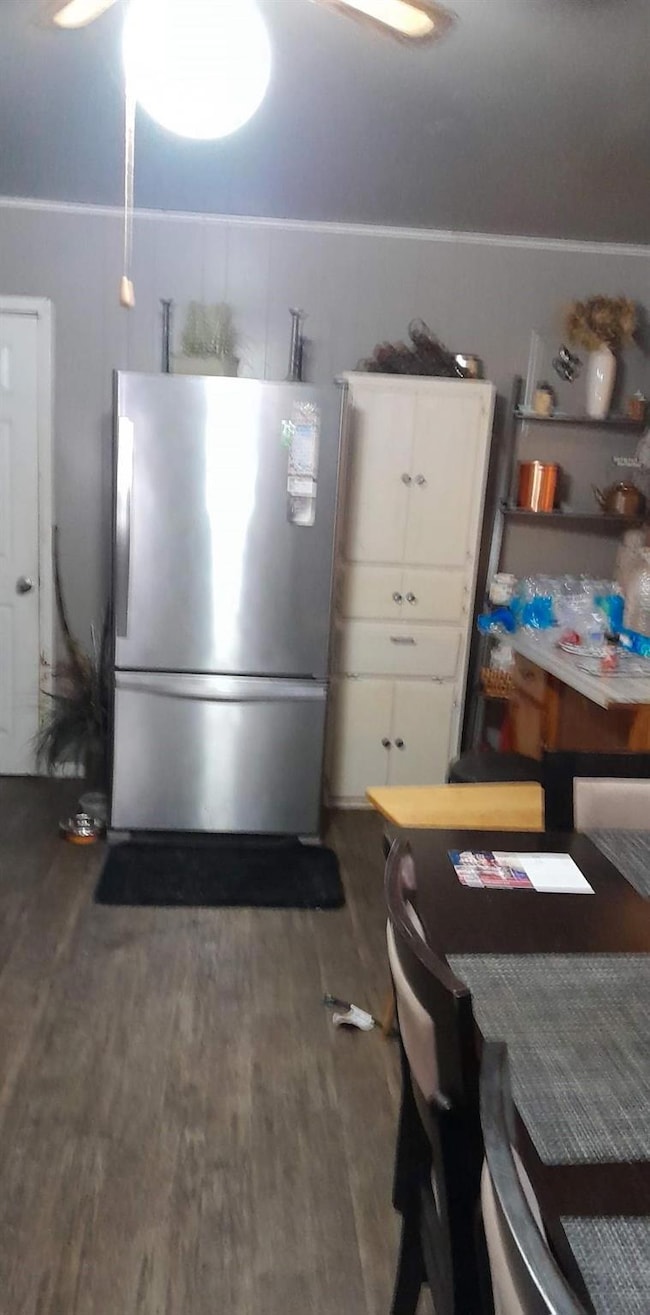 Kitchen with stainless steel refrigerator, white c