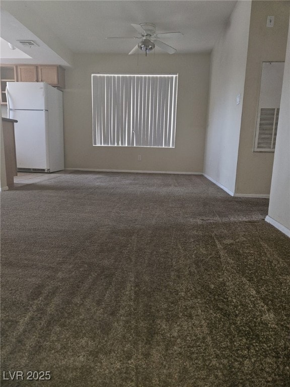 Unfurnished living room featuring a ceiling fan, c