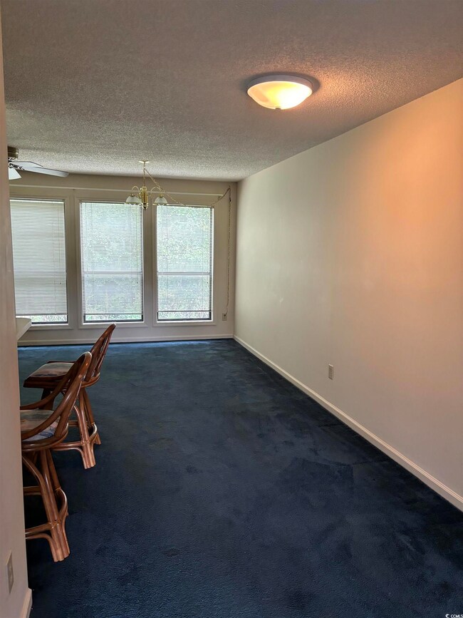 Carpeted empty room with ceiling fan with notable 