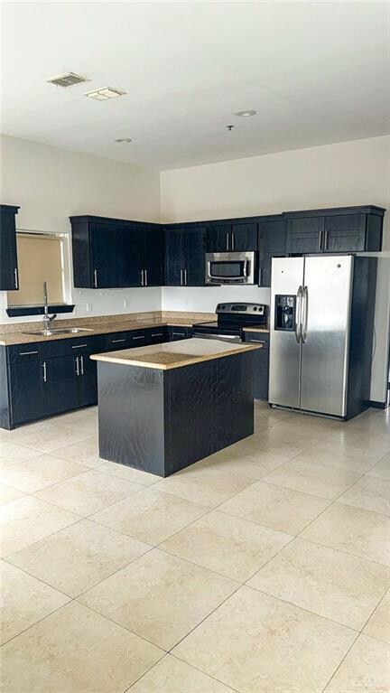 Open concept Kitchen with stainless steel appliances, open up to dining area and living room.