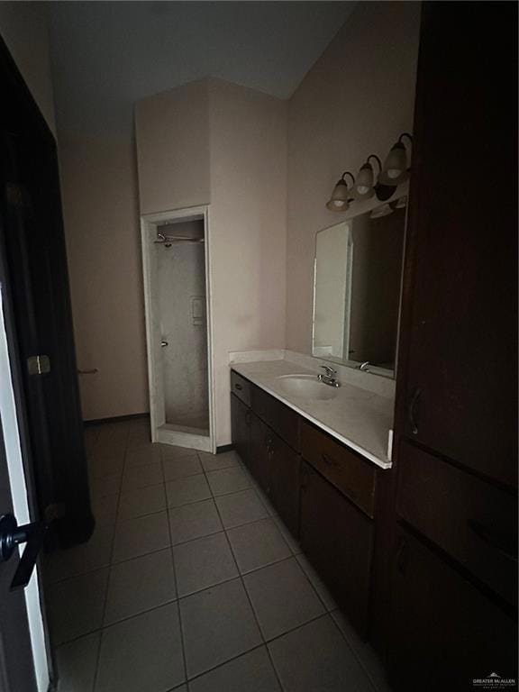 Full bath featuring vanity, tile patterned floors, and a shower