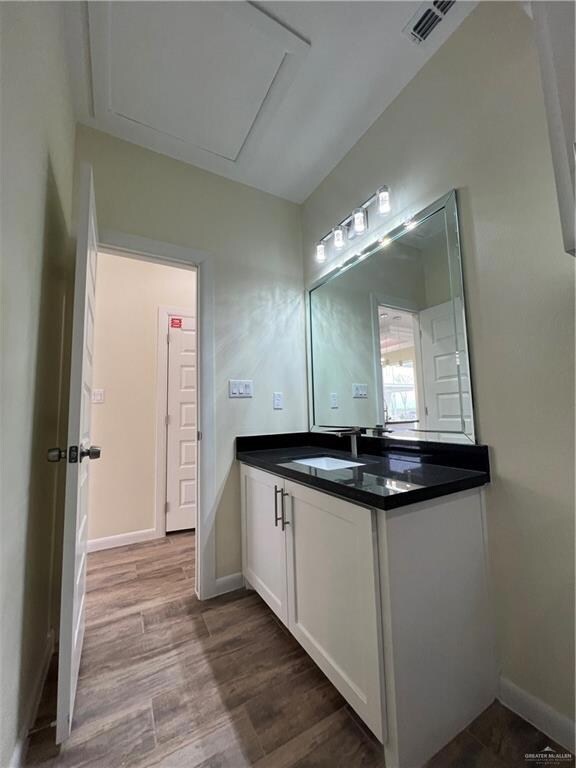 Bathroom with vanity and hardwood / wood-style flooring