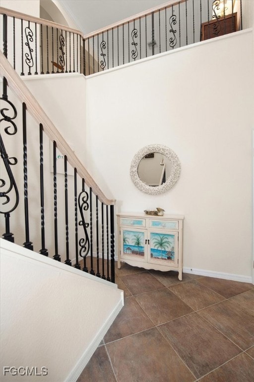 Staircase featuring baseboards and tile patterned flooring