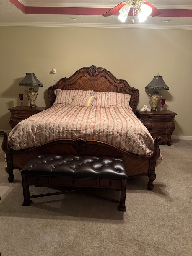 Bedroom with crown molding, carpet flooring, and c