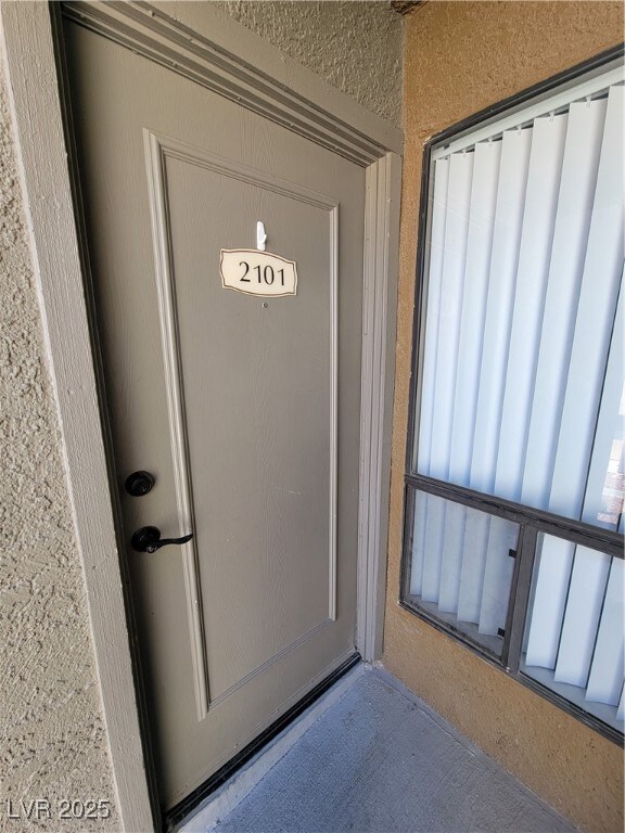 View of exterior entry featuring stucco siding