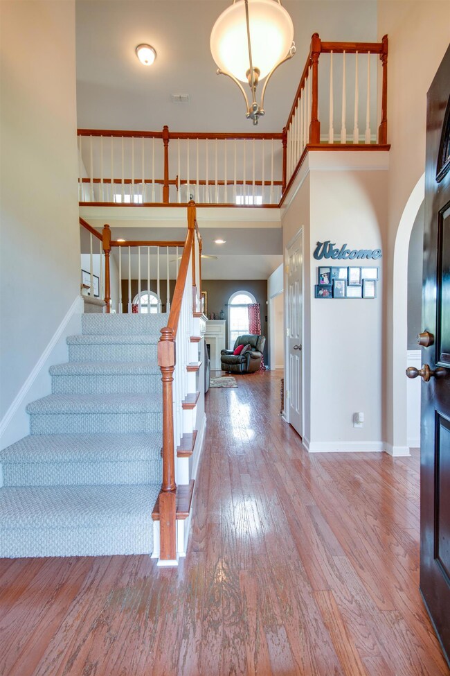 Wood flooring and soaring ceilings greet you and your guests. Stair/loft railing is beautiful.