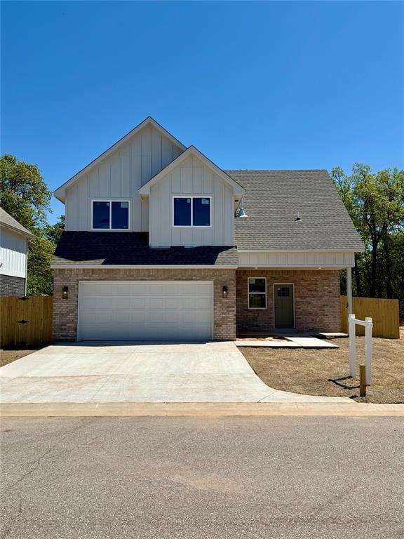 View of front of home with fence, concrete drivewa