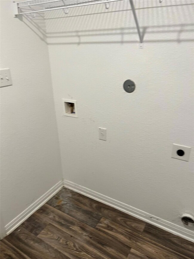 Laundry room featuring laundry area, dark wood-st