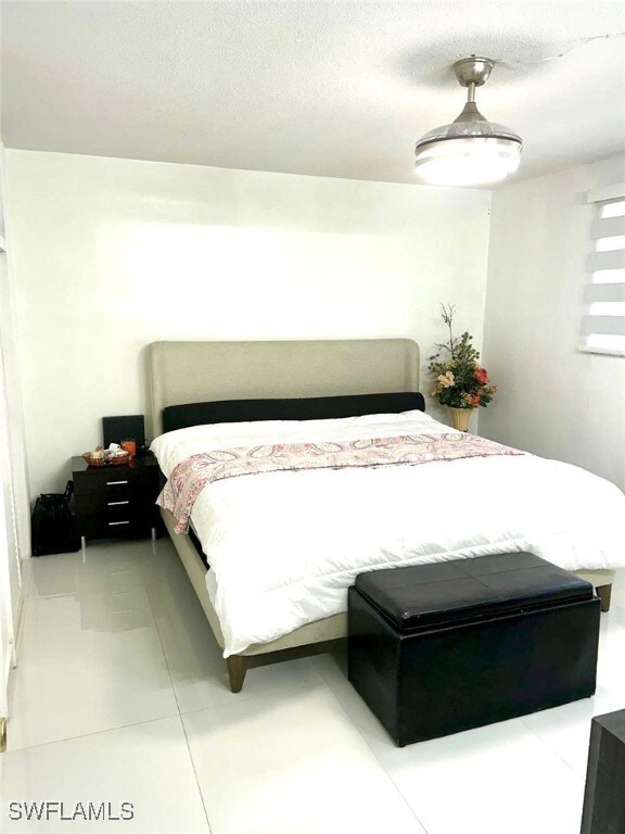 Bedroom featuring light tile patterned floors and