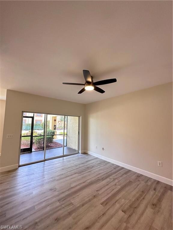 Spare room featuring baseboards, a ceiling fan, an