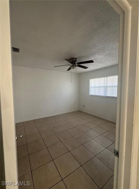 Unfurnished room with light tile patterned floors,
