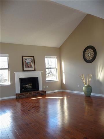 Living Room has Soaring Ceiling, Hardwood Floors and Fireplace with Gas Logs