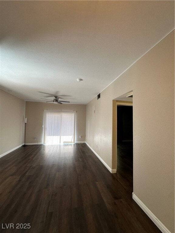 Spare room featuring dark wood finished floors and