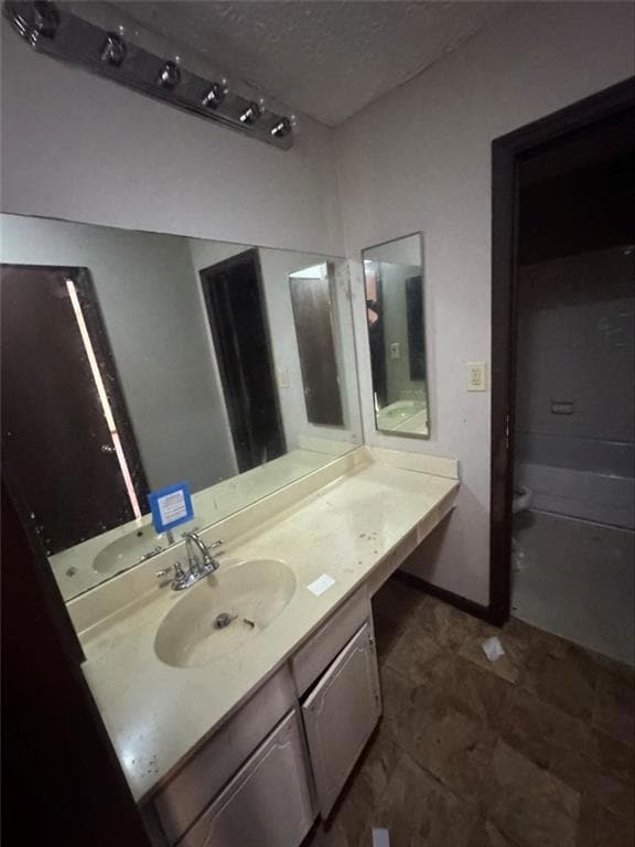 Bathroom with vanity and a textured ceiling