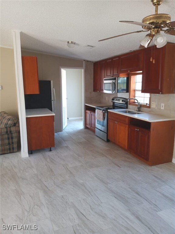 Kitchen with stainless steel appliances, a ceiling