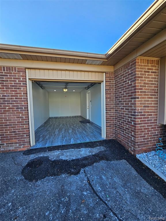 Garage with driveway and a garage door opener