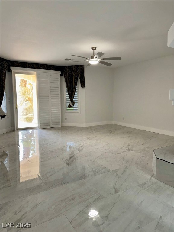 Empty room featuring light marble finish floors, h