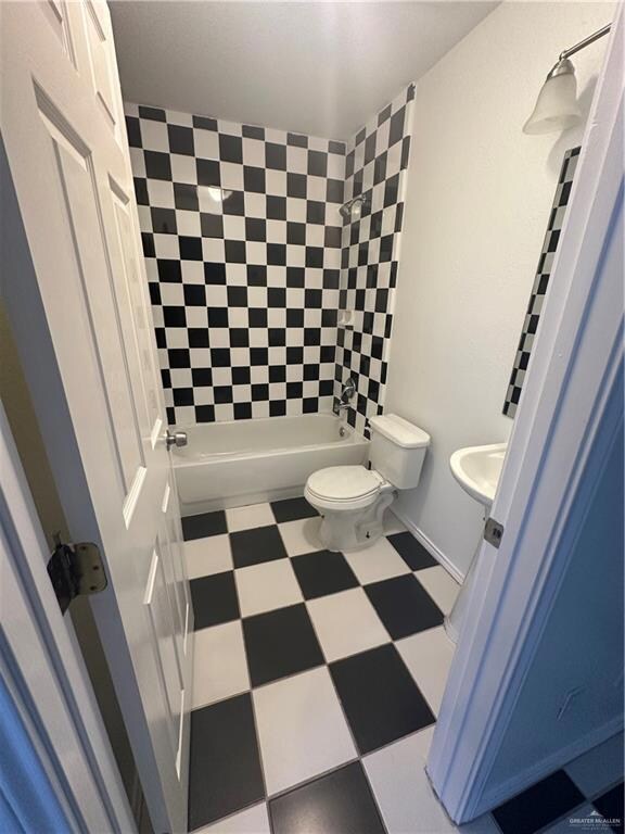 Full bath featuring tile patterned floors and shower / tub combination