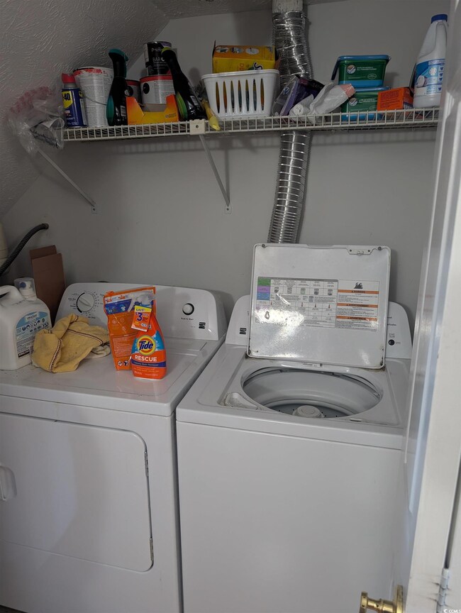 Washroom featuring washer and clothes dryer
