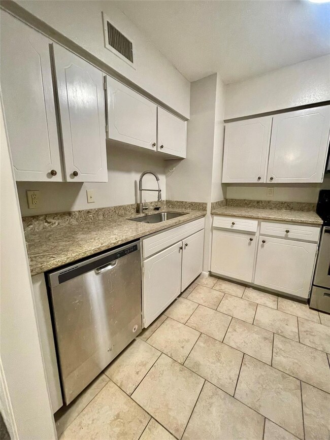 Granite countertops throughout the cozy  kitchen