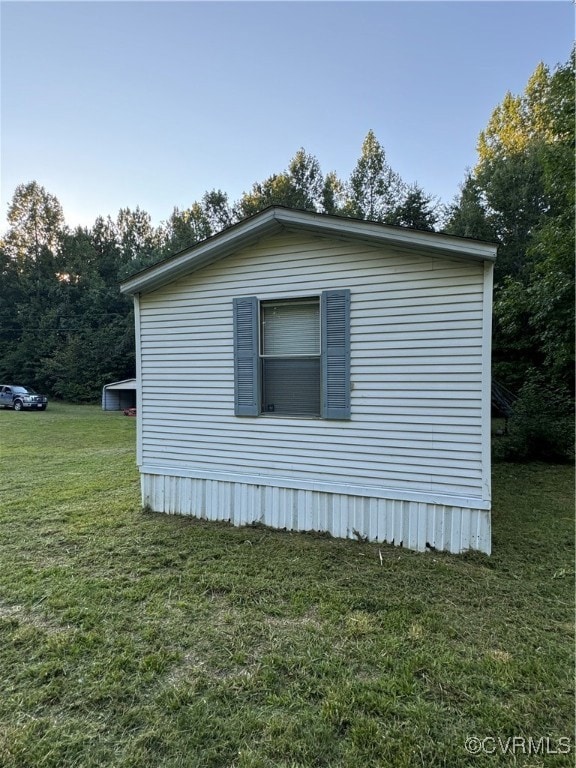View of side of home with a yard