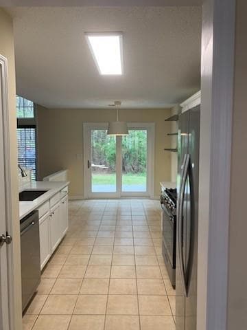 Kitchen with light tile patterned floors, gas rang