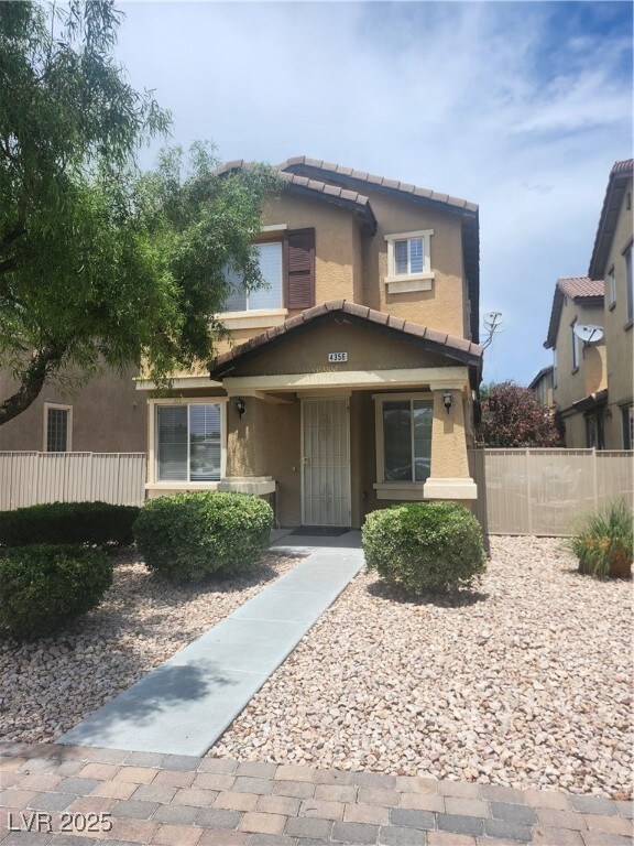 View of front of house with stucco siding, a tiled