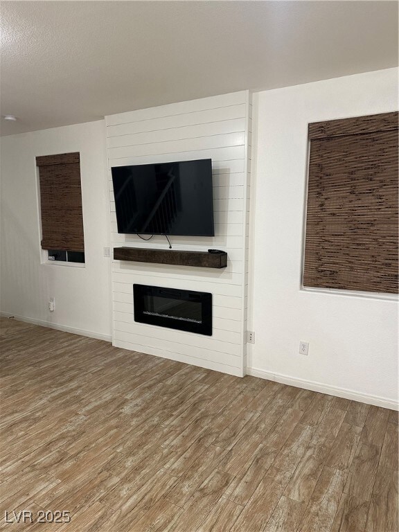 Unfurnished living room with wood finished floors